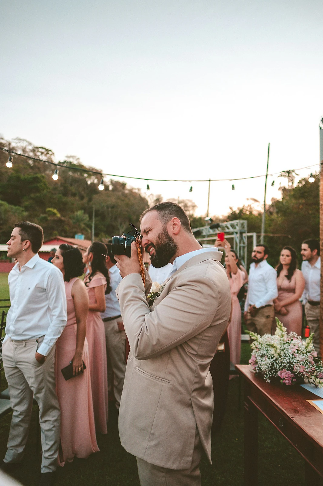Wedding photographer shooting a ceremony while guests look on