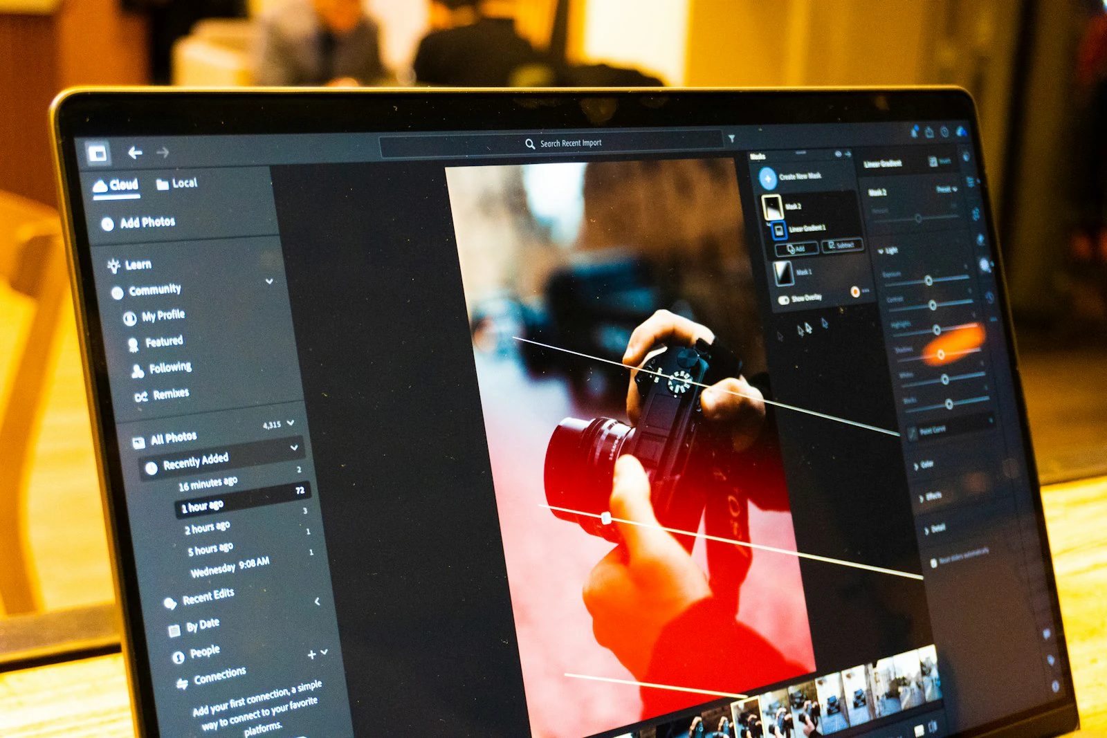 Photo editing software open on a laptop during post-shoot culling and color work