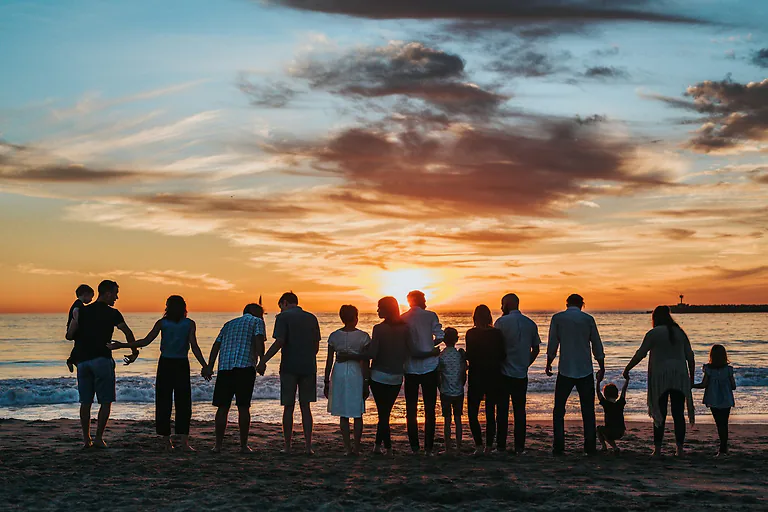 A family outdoors at sunset