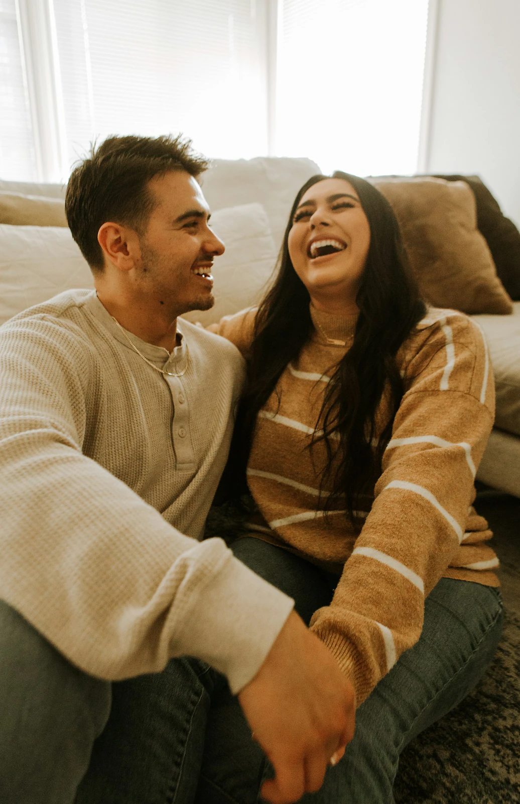 Couple laughing together in warm golden light