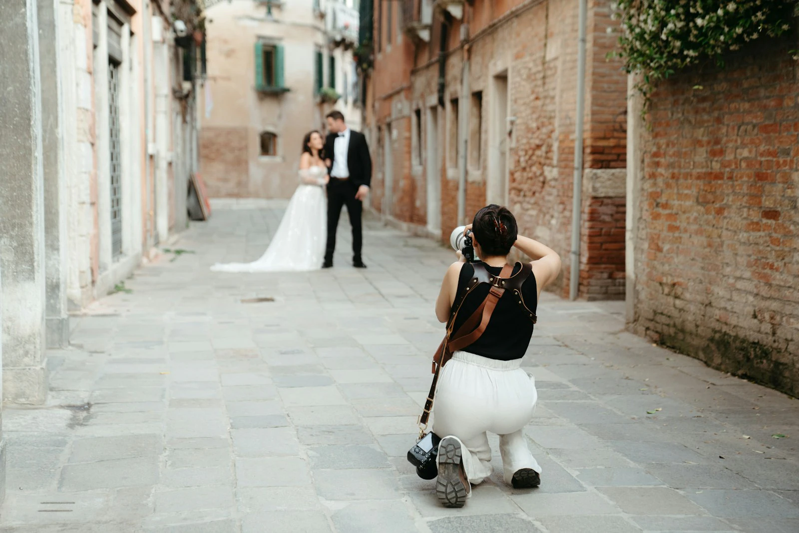 Couple posing close together in a narrow Venice alleyway during an elopement session