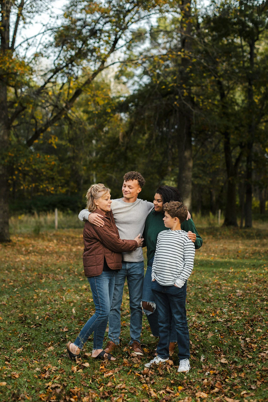 Multigenerational family embracing during an outdoor photo session