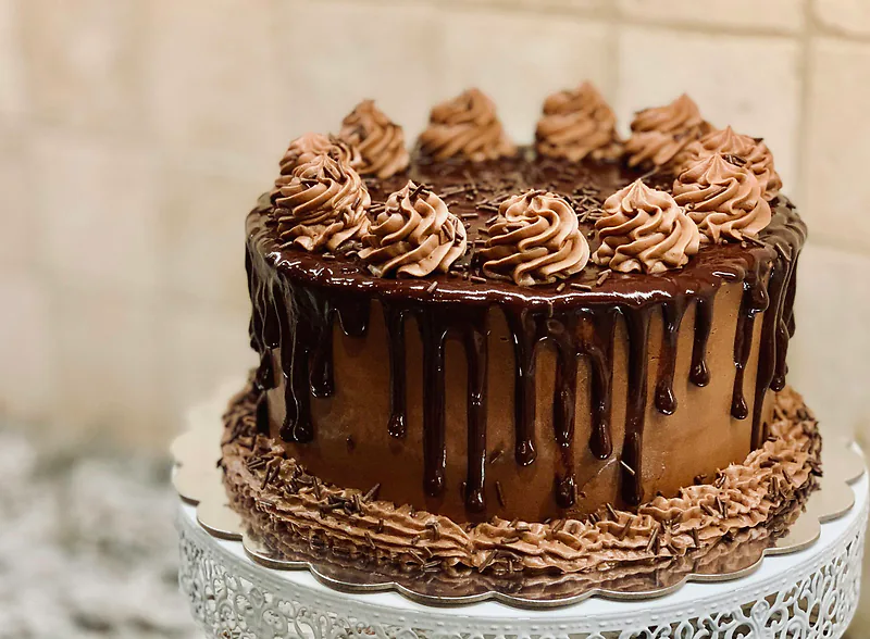 A chocolate layer cake on a stand